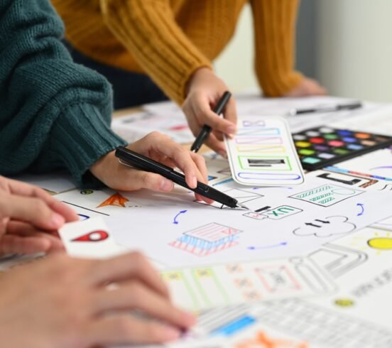 Mobile application designers brainstorming and discussing new app features at co working space office.